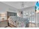 Bedroom features coastal themed decor, whitewashed trim and shuttered windows at 1555 Tarpon Center Dr # 238, Venice, FL 34285
