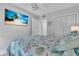 Bright bedroom features a mounted TV, ceiling fan, and double door closet at 1555 Tarpon Center Dr # 238, Venice, FL 34285