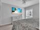 Bedroom features a wall-mounted TV, shuttered windows, and coastal decor at 1555 Tarpon Center Dr # 238, Venice, FL 34285