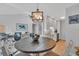 Living area featuring coastal decor and view of the open kitchen and dining area at 1555 Tarpon Center Dr # 238, Venice, FL 34285