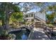 White building with water feature and bridge, lush landscaping at 1555 Tarpon Center Dr # 238, Venice, FL 34285