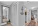 Hallway view showcasing a full length mirror and doors to a bathroom and bedroom at 1555 Tarpon Center Dr # 238, Venice, FL 34285