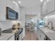 Charming kitchen area featuring white cabinets, marble countertops, and stainless appliances at 1555 Tarpon Center Dr # 238, Venice, FL 34285