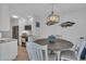 Bright kitchen area adjacent to the dining room with white shaker cabinets at 1555 Tarpon Center Dr # 238, Venice, FL 34285
