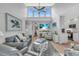 Bright living room features vaulted ceilings, coastal decor, and beachy hues at 1555 Tarpon Center Dr # 238, Venice, FL 34285