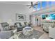 Bright living room featuring vaulted ceilings, coastal decor, and beachy hues at 1555 Tarpon Center Dr # 238, Venice, FL 34285