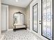 Elegant entryway with patterned tile floor and ornate mirror at 1661 Columbia Dr, Englewood, FL 34223