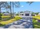 Modern farmhouse style home with a long driveway and lush lawn at 1661 Columbia Dr, Englewood, FL 34223