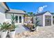 Charming patio with wicker furniture, an outdoor rug, and a white storage shed at 1661 Columbia Dr, Englewood, FL 34223