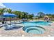 Resort-style pool area features a slide, lounge chairs, and a tranquil hot tub at 1661 Columbia Dr, Englewood, FL 34223