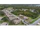 An aerial shot showcasing a community of houses nestled amongst trees and a tranquil lake at 1700 Curry Ave # 37, Nokomis, FL 34275