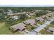 Aerial view of a community with numerous houses, lush greenery, and paved roads at 1700 Curry Ave # 37, Nokomis, FL 34275