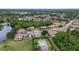 Aerial view of houses, a pool, and a large green area at 1700 Curry Ave # 37, Nokomis, FL 34275