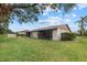 Landscaped backyard showcasing a home with screened patio at 1700 Curry Ave # 37, Nokomis, FL 34275
