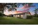 Evening view of home's backyard showcasing a screened patio at 1700 Curry Ave # 37, Nokomis, FL 34275