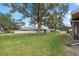 Spacious backyard with large tree and green lawn at 1700 Curry Ave # 37, Nokomis, FL 34275