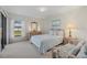 Cozy bedroom with a queen bed, dresser, and access to a patio at 1700 Curry Ave # 37, Nokomis, FL 34275