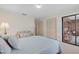 Serene bedroom with a queen bed and access to a patio at 1700 Curry Ave # 37, Nokomis, FL 34275
