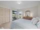 Bright bedroom with a queen bed, dresser and access to the outside at 1700 Curry Ave # 37, Nokomis, FL 34275