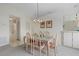 Dining area with a table, chairs, and access to the kitchen and hallway at 1700 Curry Ave # 37, Nokomis, FL 34275