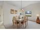 Dining room with light colored table and chairs, and chandelier at 1700 Curry Ave # 37, Nokomis, FL 34275