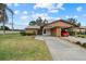Front view of house, showcasing carport and landscaping at 1700 Curry Ave # 37, Nokomis, FL 34275