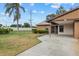 Landscaped yard and front view of single-story home with carport at 1700 Curry Ave # 37, Nokomis, FL 34275