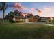 Evening view of single-story home with attached garage and lush lawn at 1700 Curry Ave # 37, Nokomis, FL 34275