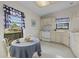 Eat-in kitchen with white cabinets, appliances, and a corner sink at 1700 Curry Ave # 37, Nokomis, FL 34275