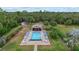 Community pool with lounge chairs, a shaded area, and lush landscaping at 1700 Curry Ave # 37, Nokomis, FL 34275