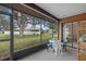 Bright screened patio furnished with table and chairs, overlooking a tranquil backyard at 1700 Curry Ave # 37, Nokomis, FL 34275