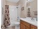 Clean bathroom with shower/tub combo, wood vanity, and white tile at 173 Padova Way # 17, Nokomis, FL 34275