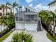 Modern two-story home with paver driveway and tropical landscaping at 176 Emerson Dr, Sarasota, FL 34236