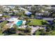 Community pool, clubhouse, and BBQ area with lush landscaping at 18 Oakwood N Dr # 18, Englewood, FL 34223