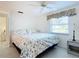 Bedroom with floral bedding and window at 18 Oakwood N Dr # 18, Englewood, FL 34223