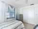 Bedroom with twin bed, dresser, and window with blinds at 18 Oakwood N Dr # 18, Englewood, FL 34223