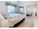 Bedroom with mirrored closet and floral bedding at 18 Oakwood N Dr # 18, Englewood, FL 34223