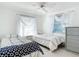 Bright bedroom with twin beds, window, and dresser at 18 Oakwood N Dr # 18, Englewood, FL 34223