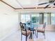 Bright dining area with glass-top table and seating for four at 18 Oakwood N Dr # 18, Englewood, FL 34223