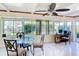 Sun-drenched dining area with glass table and chairs at 18 Oakwood N Dr # 18, Englewood, FL 34223