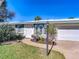 Florida home with landscaped yard, attached garage, and walkway at 18 Oakwood N Dr # 18, Englewood, FL 34223