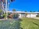 House with lush landscaping and a spacious lawn at 18 Oakwood N Dr # 18, Englewood, FL 34223