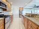 Bright kitchen boasts granite countertops and stainless steel appliances at 18 Oakwood N Dr # 18, Englewood, FL 34223