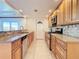 Galley-style kitchen with granite counters and stainless steel appliances at 18 Oakwood N Dr # 18, Englewood, FL 34223