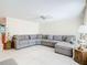 Living room featuring a sectional sofa and ample space at 18 Oakwood N Dr # 18, Englewood, FL 34223