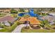 Aerial view of house near lake in a residential community at 1815 Killdeer Ct, Venice, FL 34293