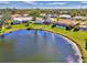 Community overview showing houses near a pond at 1815 Killdeer Ct, Venice, FL 34293