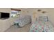 Bedroom with twin beds, floral bedding, and a TV at 1815 Killdeer Ct, Venice, FL 34293