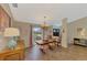 Bright dining room with wooden table and chairs, and hardwood floors at 1815 Killdeer Ct, Venice, FL 34293