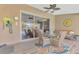 Relaxing enclosed patio with wicker furniture, overlooking pool and lake at 1815 Killdeer Ct, Venice, FL 34293